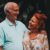 Sandra and Peter, an older couple looking at each other and smiling broadly